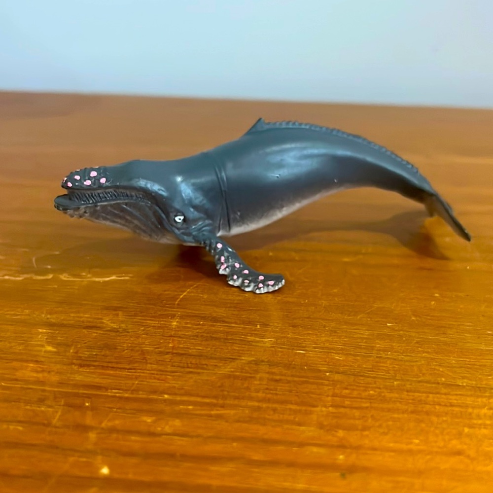 Whale figure with pink spots and a grey base